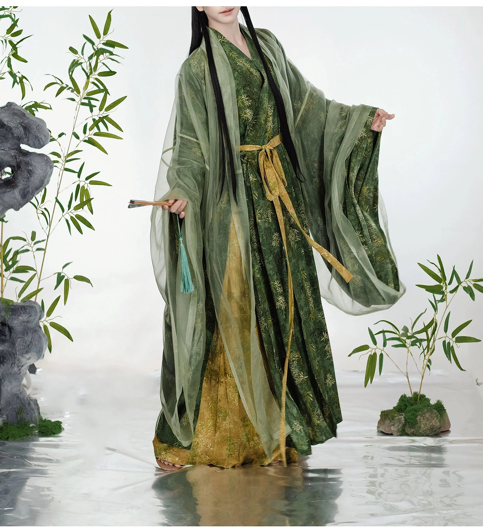 Front full-body view of the complete green bamboo leaf print Song Dynasty Hanfu robe and pants set with golden sash, wide sleeves, traditional hairstyle, and tassel accessory