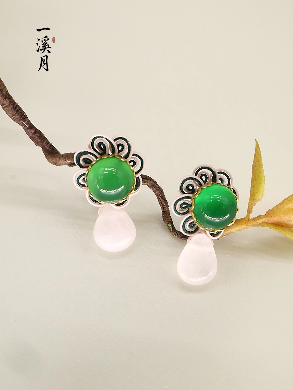 Green chalcedony flower drop stud earrings with pink teardrop pendants displayed on natural branches, Chinese qipao jewelry side view