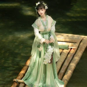 Green and cream Tang Dynasty Hanfu Beizi Qiyao Ruqun set shown from the front three-quarter view on a bamboo raft, featuring a flowing light green outer layer, striped high-waisted skirt, decorative sash, and tassels