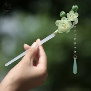 Single traditional Chinese hair stick with light green flowers, matching buds, dangling bead chain, and milky white jade-style rod