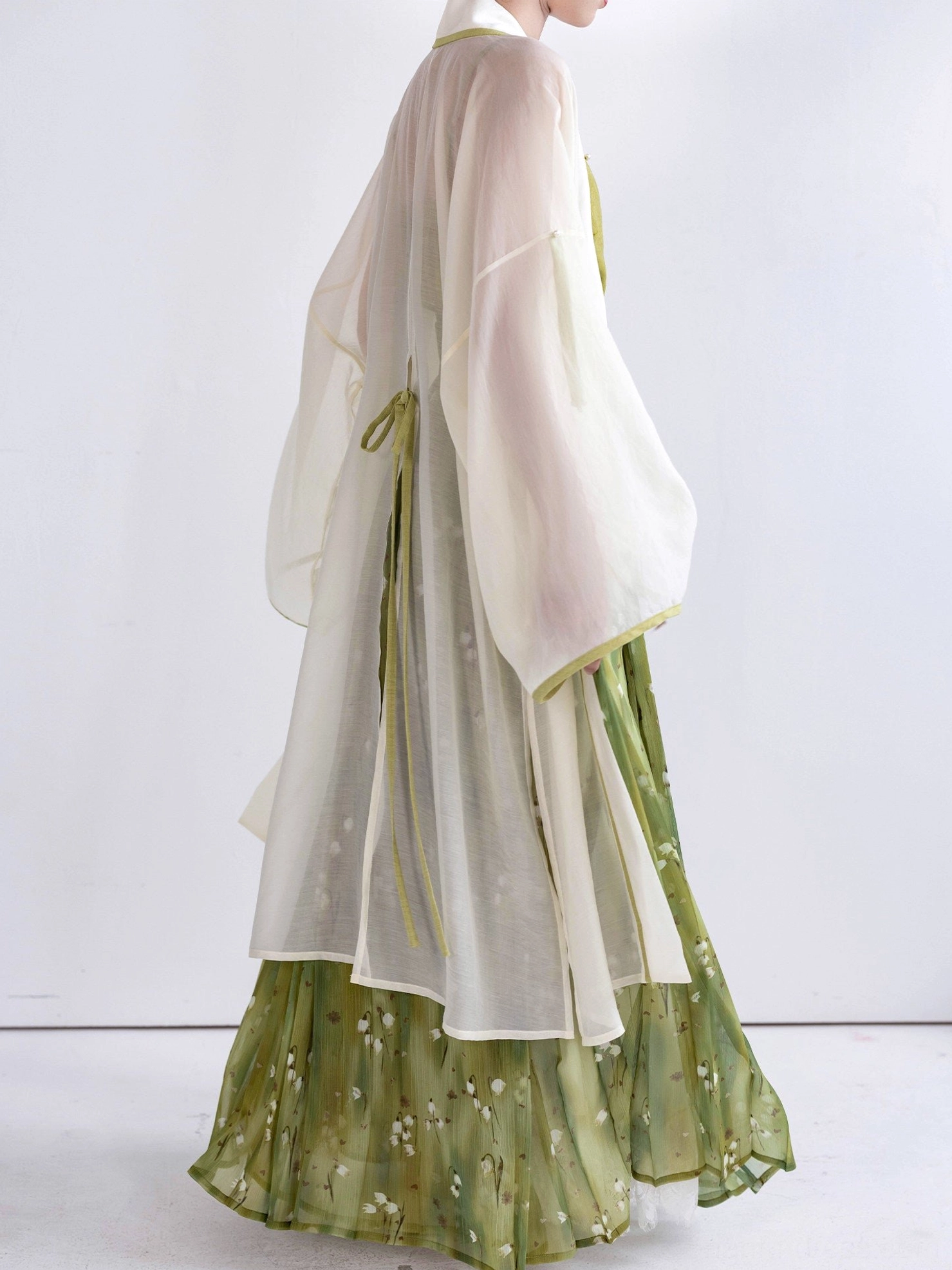 Green floral Song Dynasty Hanfu full set displayed without model showing ivory sheer cardigan, camisole and pleated wrap skirt