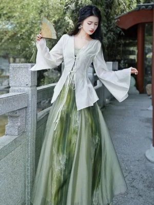 Three-quarter view of a green modern Hanfu dress set with watercolor gradient maxi dress, lightweight cardigan, and traditional Chinese garden styling