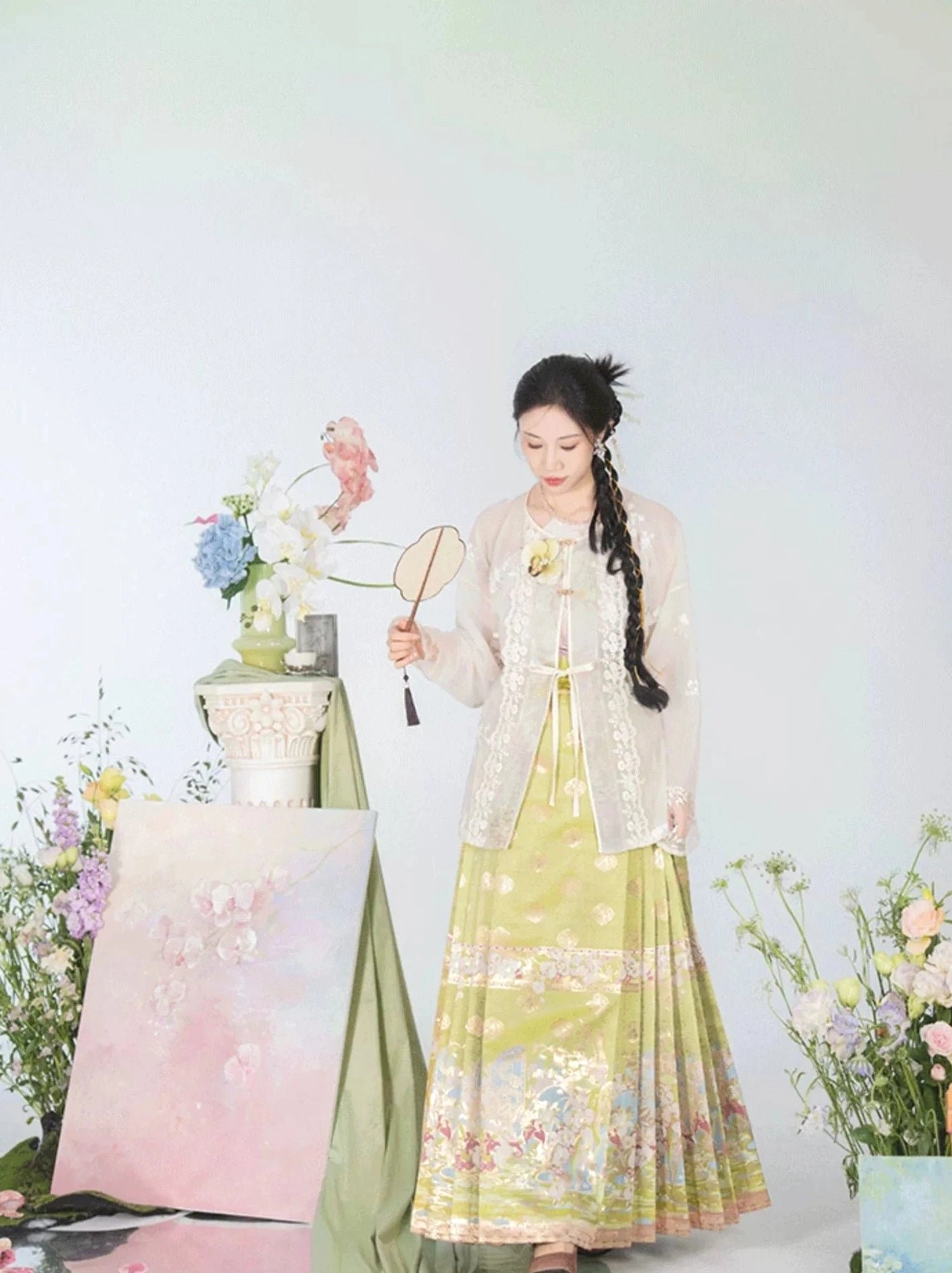 Green and yellow modern Hanfu mamian skirt with sheer embroidered cardigan and elegant gilded landscape artwork