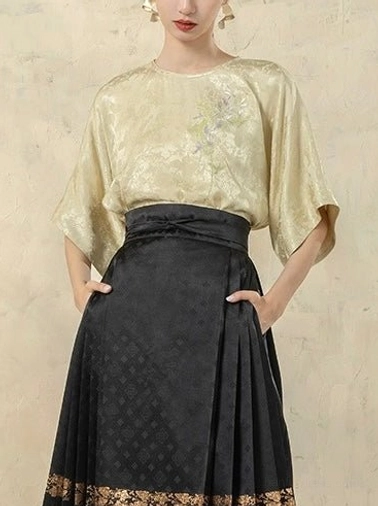 Green satin modern Hanfu top with delicate floral embroidery, textured jacquard fabric, round neck, elbow-length dolman sleeves, and black horse-face skirt