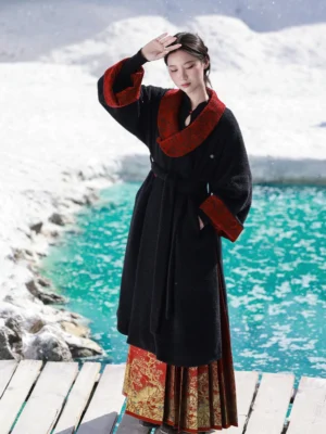 Gryffindor-inspired Tang Dynasty Hanfu winter coat in black chenille with red jacquard collar, styled on a snowy lakeside dock