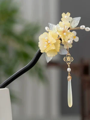 Haitang floral Chinese hair stick with dark shaft, yellow blossoms, pale blue leaves, pearl accents and jade-look tassel close-up