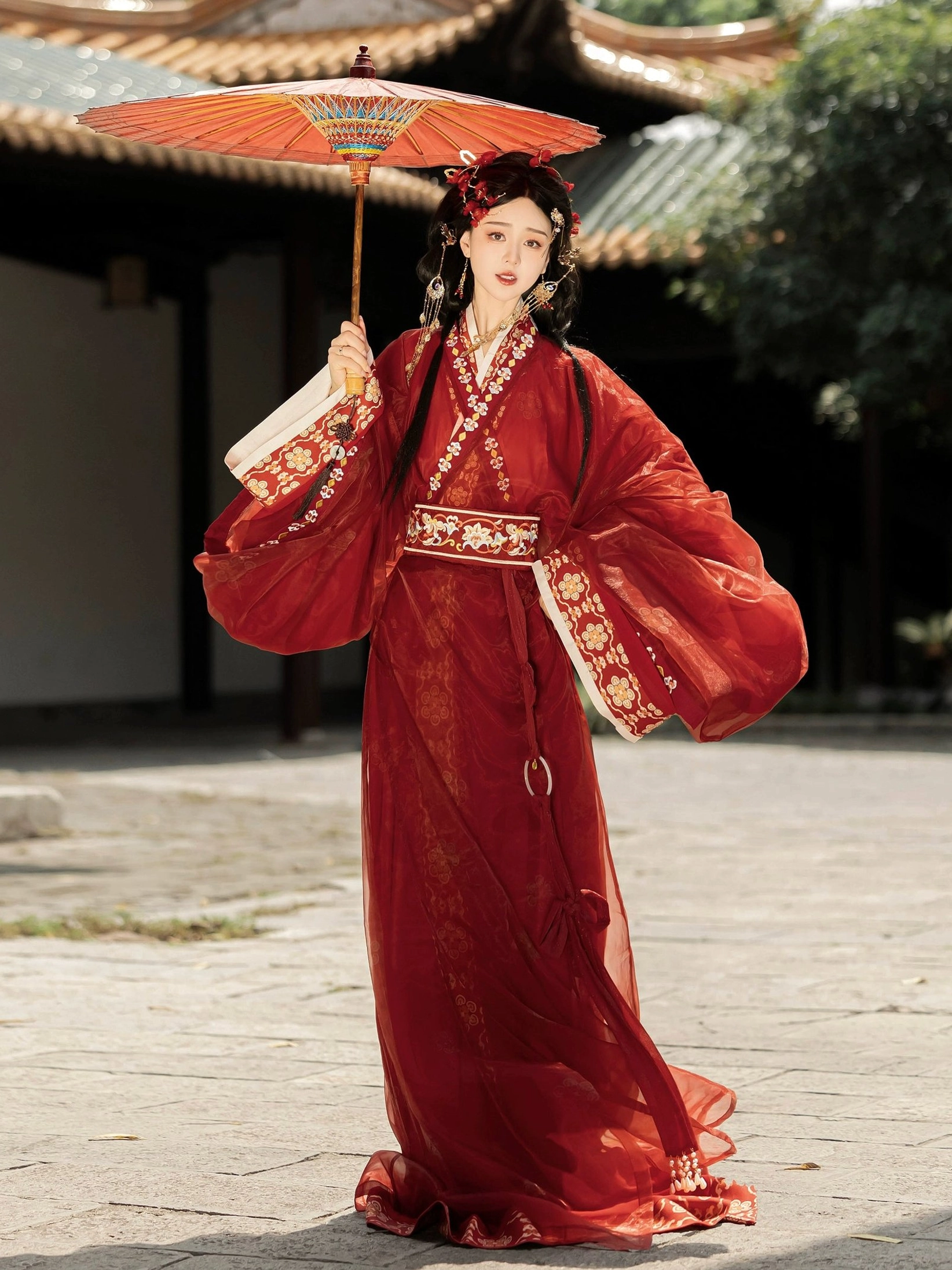 Red Han Dynasty straight hem Hanfu floor-length robe with floral pattern embroidered sleeves and oil paper umbrella in ancient courtyard