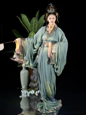 Three-quarter view of a Han Dynasty inspired straight hem hanfu robe with glossy cyan satin fabric, gold decorative edging, waist sash, layered collar, and traditional Chinese styling