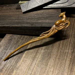 Hand-carved nine-tailed fox wooden Chinese hair stick shown in full on a dark wood background, a myth-inspired Hanfu hair accessory with a chestnut brown finish