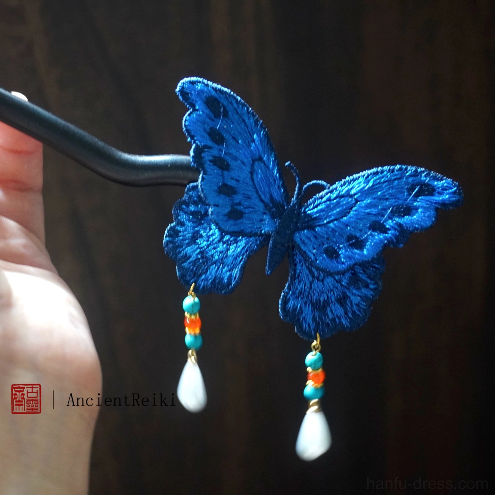 Handheld blue embroidered butterfly traditional Chinese hair stick showing full beaded tassel ornament