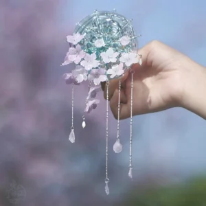 Frontal view of a handmade Chinese hair stick accessory featuring layered cherry blossom flowers cascading silver chains and glass teardrop charms