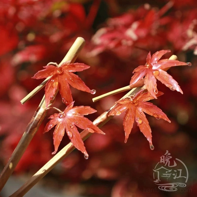 Side view of handmade Chinese maple hair stick with double red leaf decoration and natural wood shaft