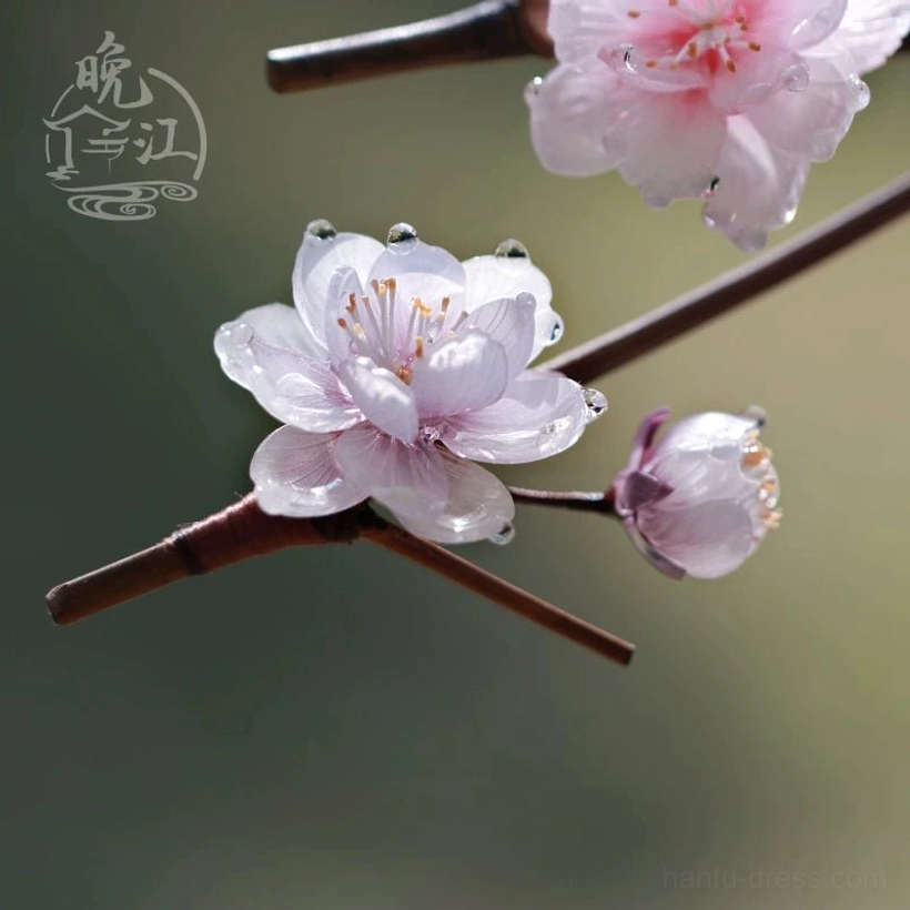 Detailed view of handmade pink translucent resin plum blossom hair stick components with dewdrop decorations and wooden shafts