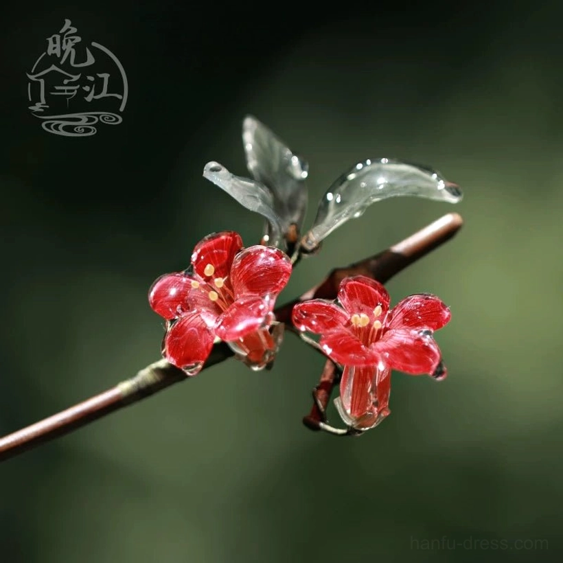 Detailed side view of a handmade red crabapple flower hair stick with glossy translucent petals, water-like finish, green leaves, and brown stick