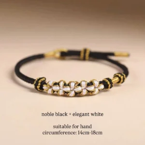 Handwoven Chinese knot bracelet with black braided cord white and gold clover-shaped woven decorations and gold-toned accents for Hanfu Qipao and everyday Chinese-inspired fashion