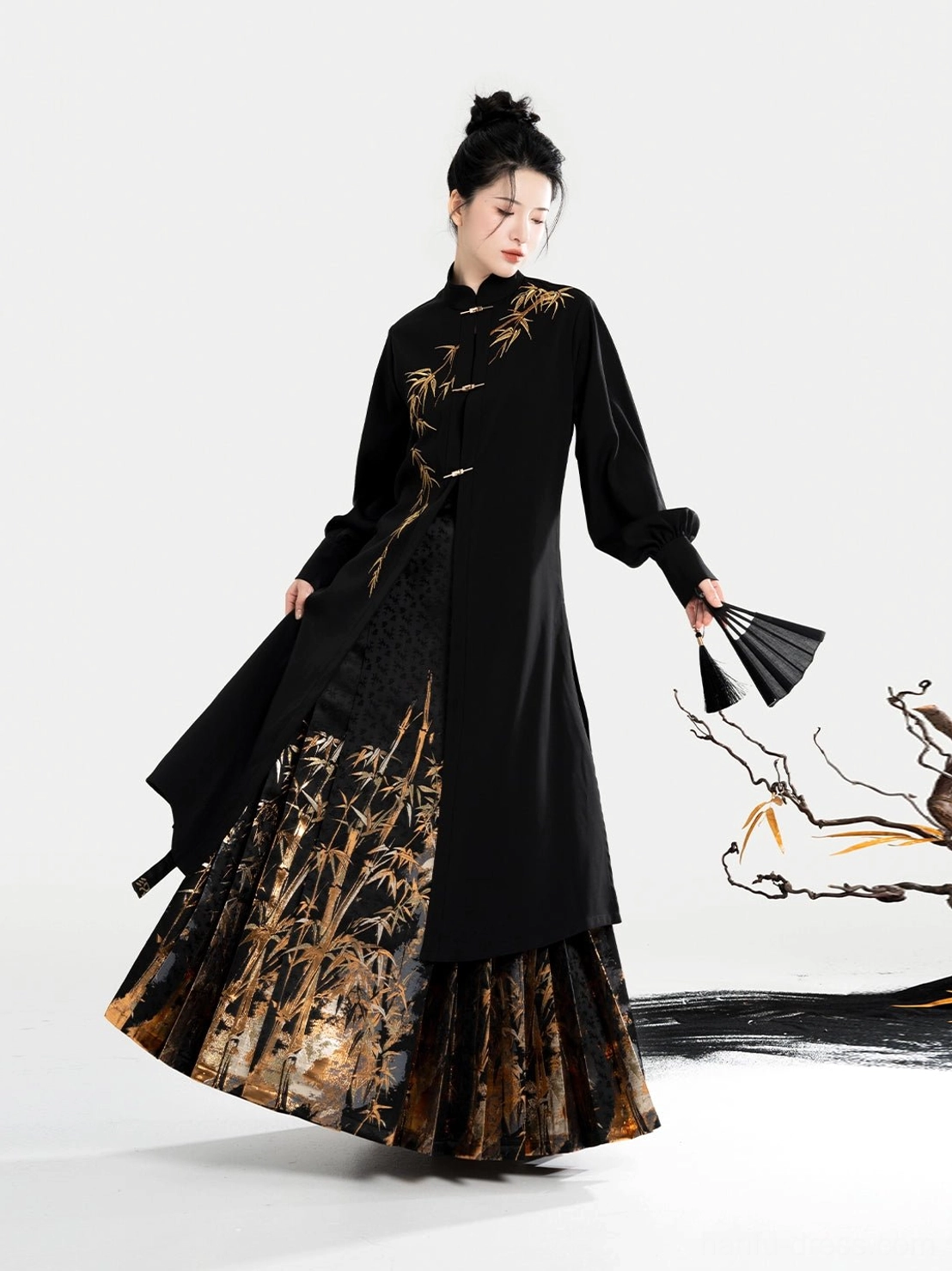 Three-quarter side view of a flowing black Hanfu blouse and golden bamboo patterned mamian skirt