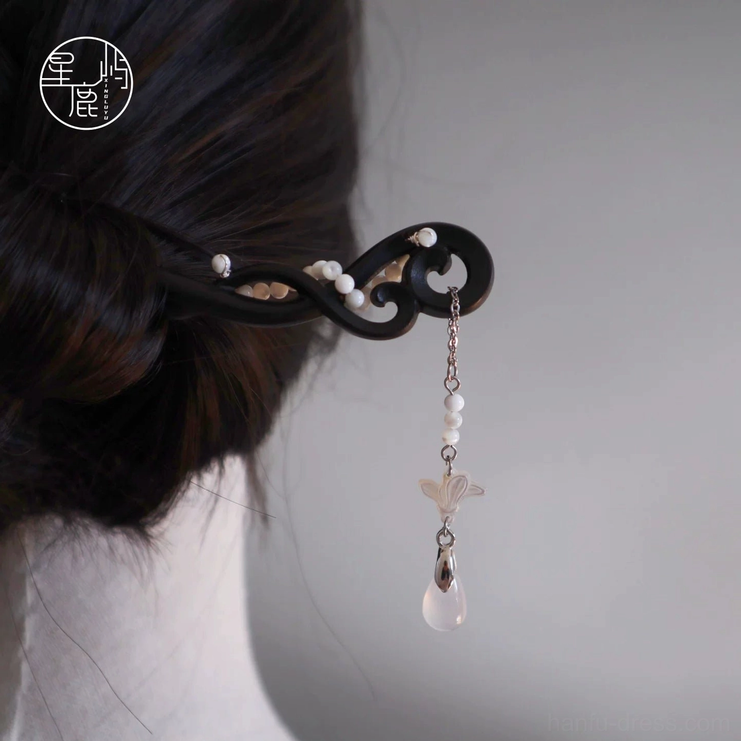 Hanfu compatible Chinese wooden hair stick with curly carved body, white bead accents, silver hanging tassel, shell flower, and water drop pendant