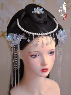 Traditional Chinese Hanfu hairstyle featuring blue purple glazed flower hair pins pearl forehead chain and long crystal tassels on a mannequin