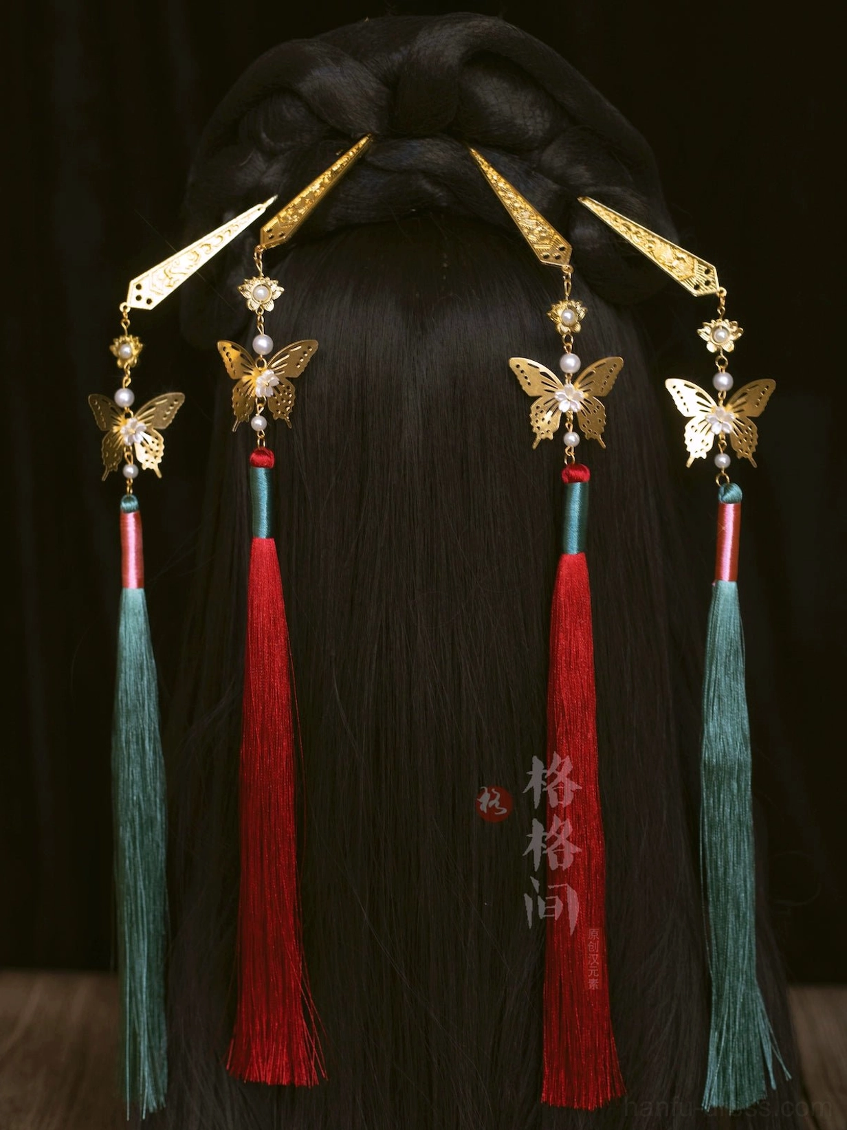 Back view of an elegant Hanfu hairstyle decorated with red and green Chinese butterfly tassel hair pins