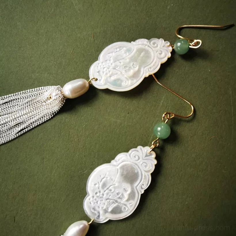 Hanfu hook earrings with carved shell pendants, silver tassel chains, gold hooks, pearls, and green jade accents