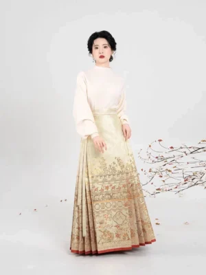Front view of an off-white cross-collar hanfu inner top styled with a gold jacquard mamian skirt and red hem