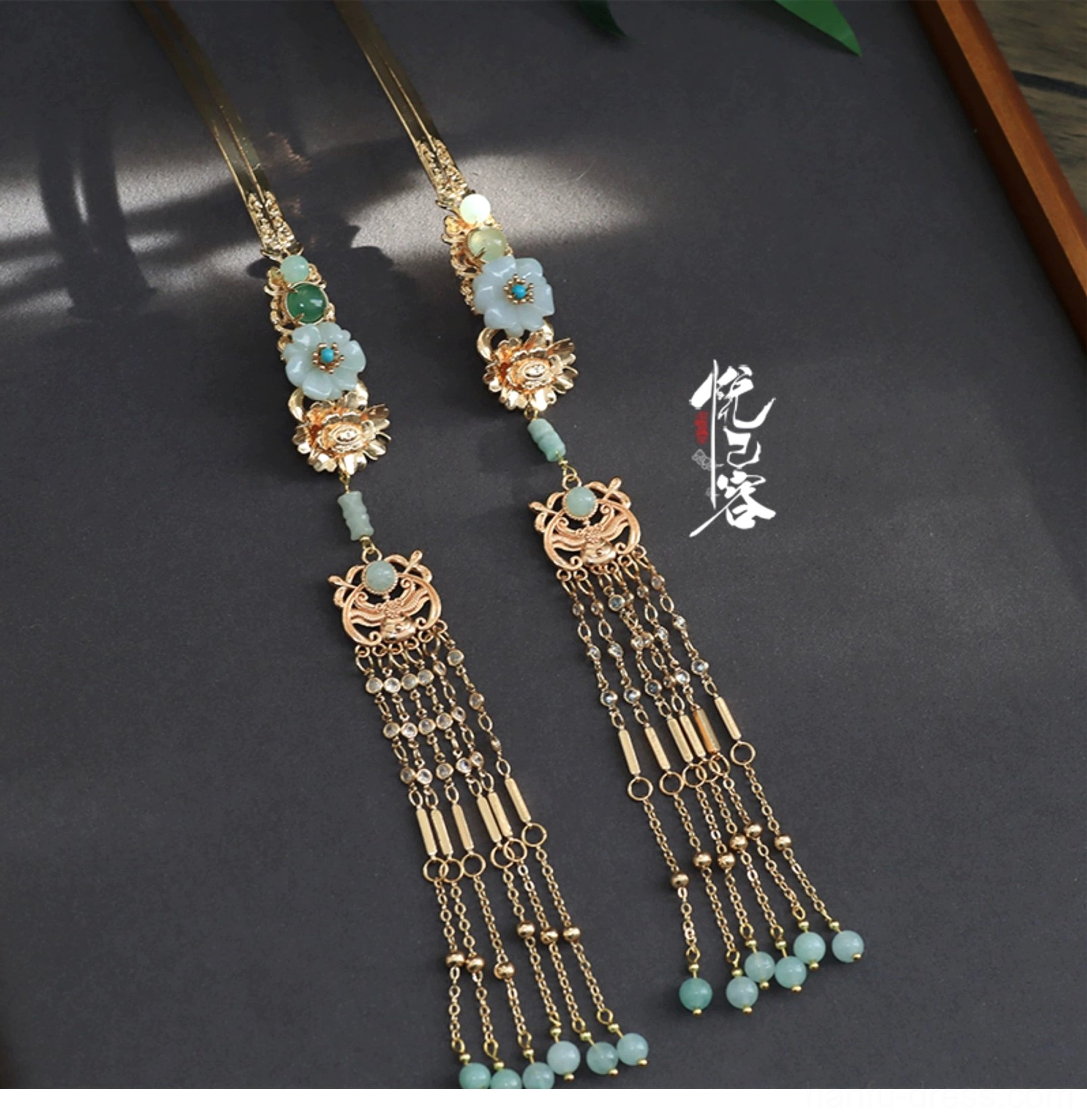 Pair of traditional Chinese Hanfu side tassel hairpins with gold chains, green jade-inspired beads, vintage flower details, and hanging pendants