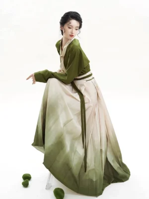 Side view of a flowing Chinese Hanfu outfit showing the gradient mountain-print mamian skirt and long green waist ties