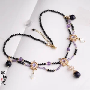 Full flat-lay view of a Hanfu-style Chinese necklace featuring dual-layer bead chains, gold-tone hardware, dark pendants, clear teardrop charms, and adjustable extension chain