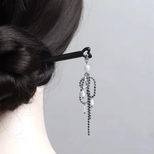 Hanfu tassel hair stick securing a neat low bun from the back with layered chains and white decorative beads