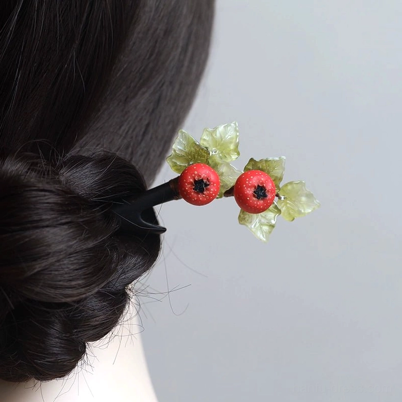 Hawthorn fruit Chinese hair stick displayed in a traditional coiled Hanfu hairstyle with two red berries and layered light green leaves