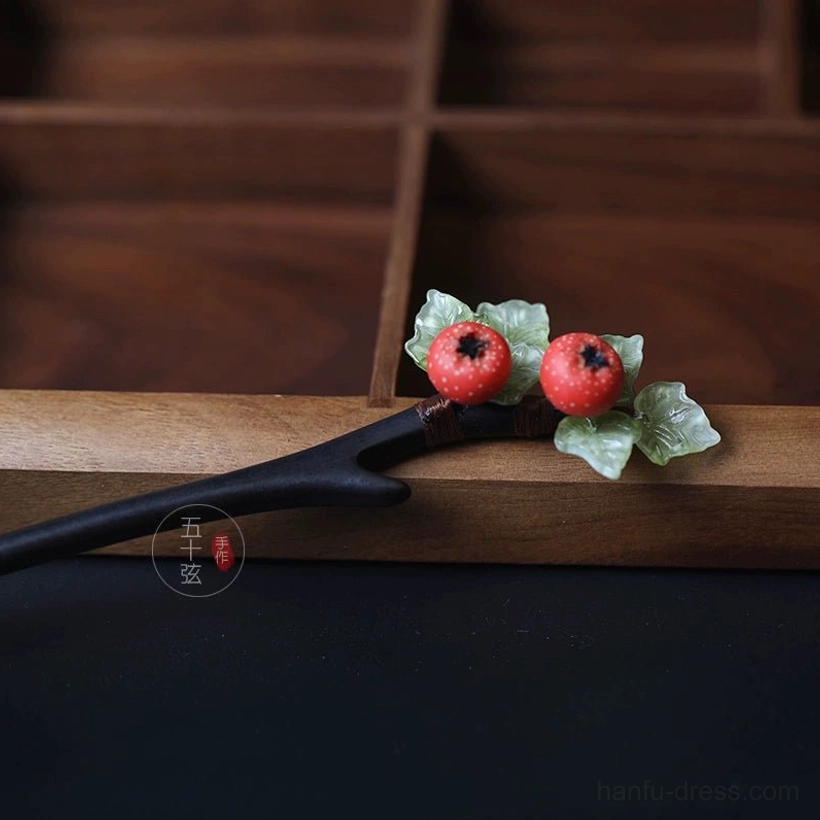 Hawthorn fruit hair stick shown from the top-side angle with botanical red berry ornament on a dark Chinese hairpin