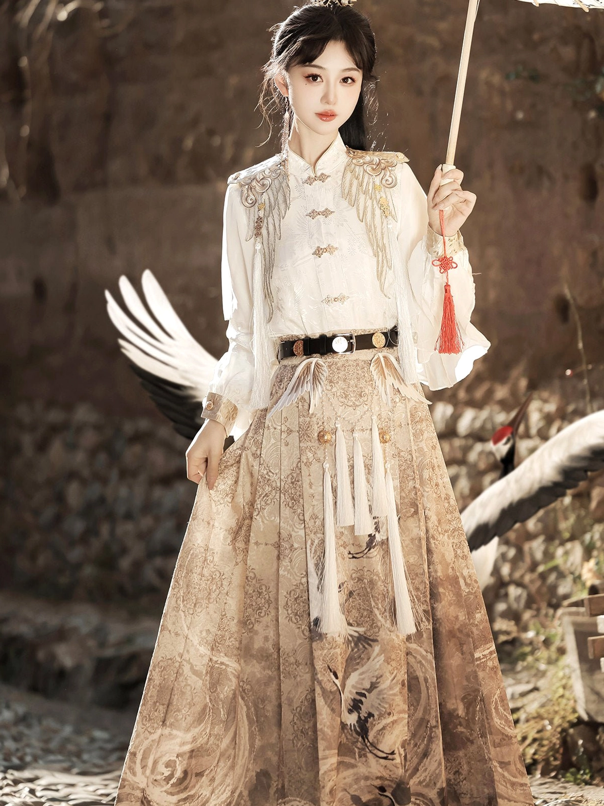 Heavenly Envoy Hanfu two piece outfit with white lantern sleeve blouse, khaki crane and cloud mamianqun skirt, red waist tassel, and paper umbrella styling