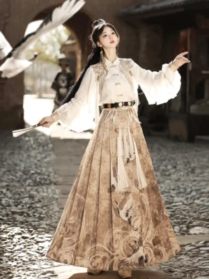Heavenly Envoy Chinese Hanfu set with white lantern sleeve top, embroidered shoulder details, khaki crane print mamianqun skirt, black waist belt, and tassel decorations on an ancient town street