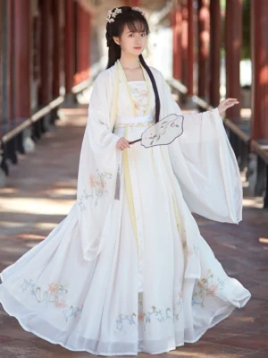 White Song Dynasty qiyao ruqun hanfu complete set with floral embroidery, wide sleeves, yellow waist trim, and flowing skirt in a traditional Chinese corridor