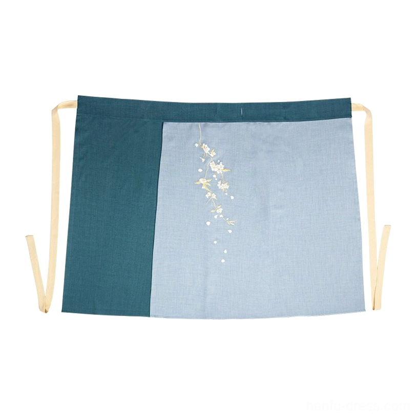Flat lay of a high-waisted two-tone Hanfu wrap skirt in light blue and dark green with beige sash and pear blossom embroidery