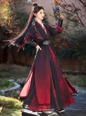 Side view of Hongchen Wei Jin Dynasty warrior Hanfu outfit in red and black with embroidered bracers, flowing pleated skirt, and traditional demon mask in an autumn garden