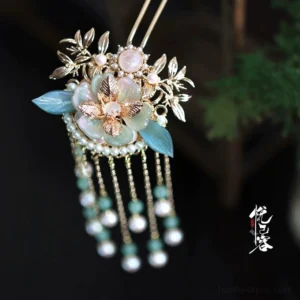Front close-up of Hua Jintu Chinese Hanfu hairpin with pink floral centerpiece, blue jade-style leaves and pearl bead tassels