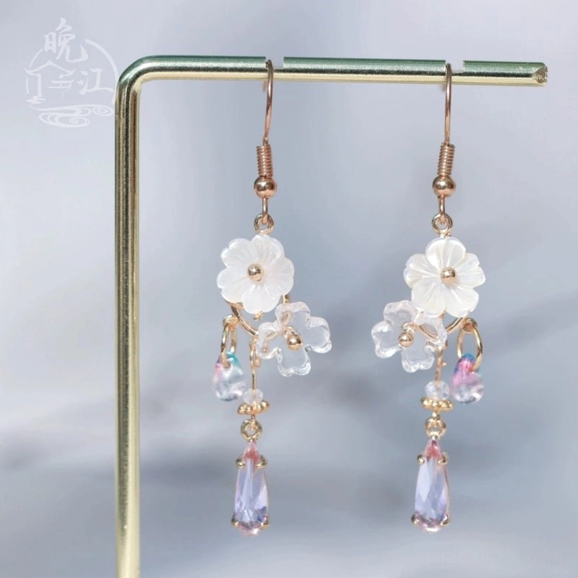Pair of Chinese floral hook earrings showing layered shell flowers, iridescent beadwork, and dangling purple teardrop pendants