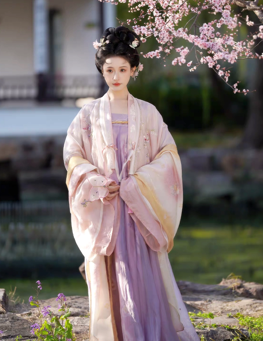 Front view of Hundred Flowers Scroll Tang Dynasty hanfu full set with pink wide sleeves, lavender skirt, flower hair ornaments and Famen Temple inspired shawl