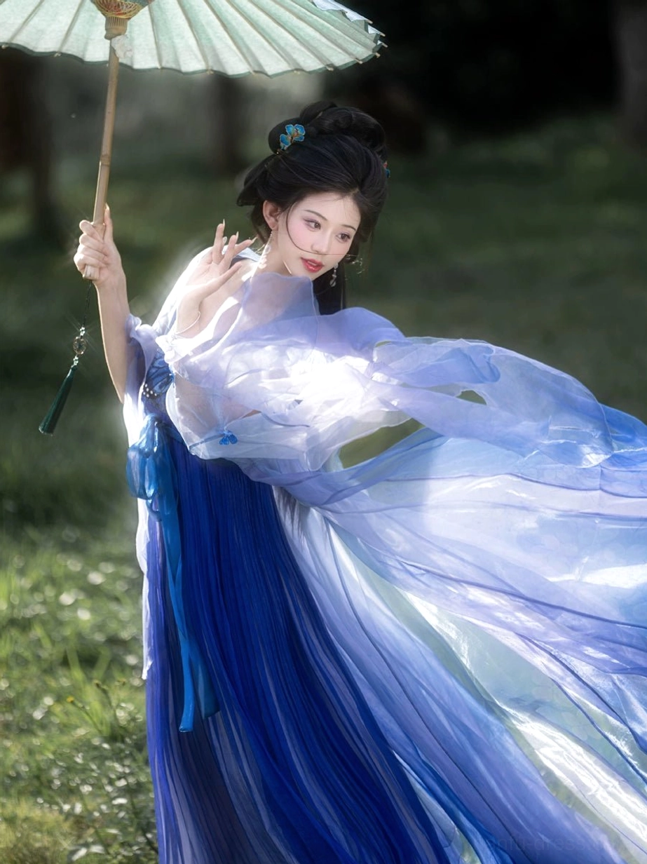 Illusory Butterfly Tang Dynasty Hanfu dress styled with an oiled paper umbrella, gradient blue sheer outer coat, wide waist sash, delicate butterfly embroidery, and dramatic flowing sleeves