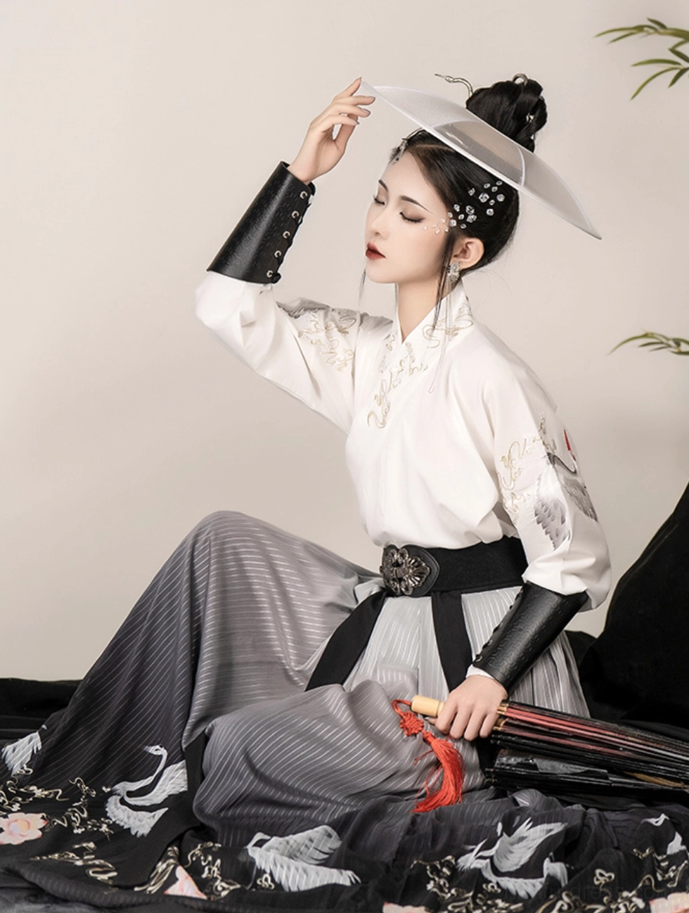 White crane embroidery wuxia Hanfu detail featuring embroidered sleeve, metal waist buckle and flowing gradient pleated skirt