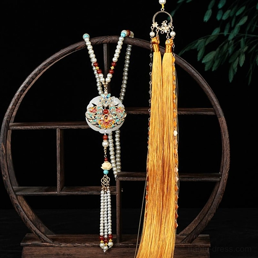 Layered Chinese yingluo necklace with pearl strands, colorful beads, floral pendant and elegant golden tassel displayed in a vintage setting