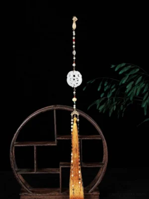 Chinese style yingluo tassel necklace detail featuring a round white floral pendant, colorful beads, gold-tone chain and golden silk tassel