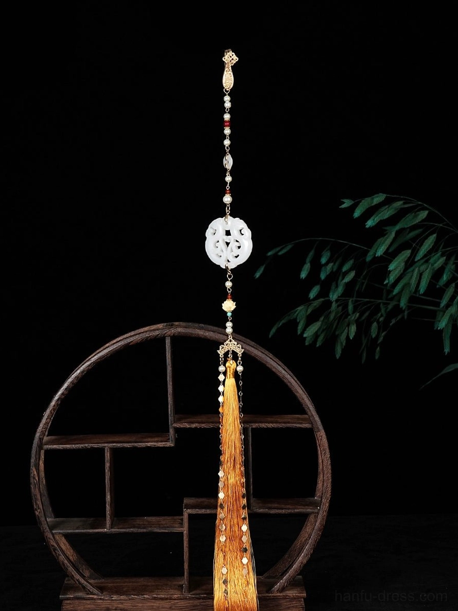Chinese style yingluo tassel necklace detail featuring a round white floral pendant, colorful beads, gold-tone chain and golden silk tassel