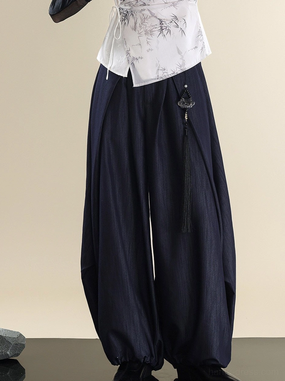 Close up of ink bamboo print Modern Hanfu top waist and dark textured denim pants tassel pendant