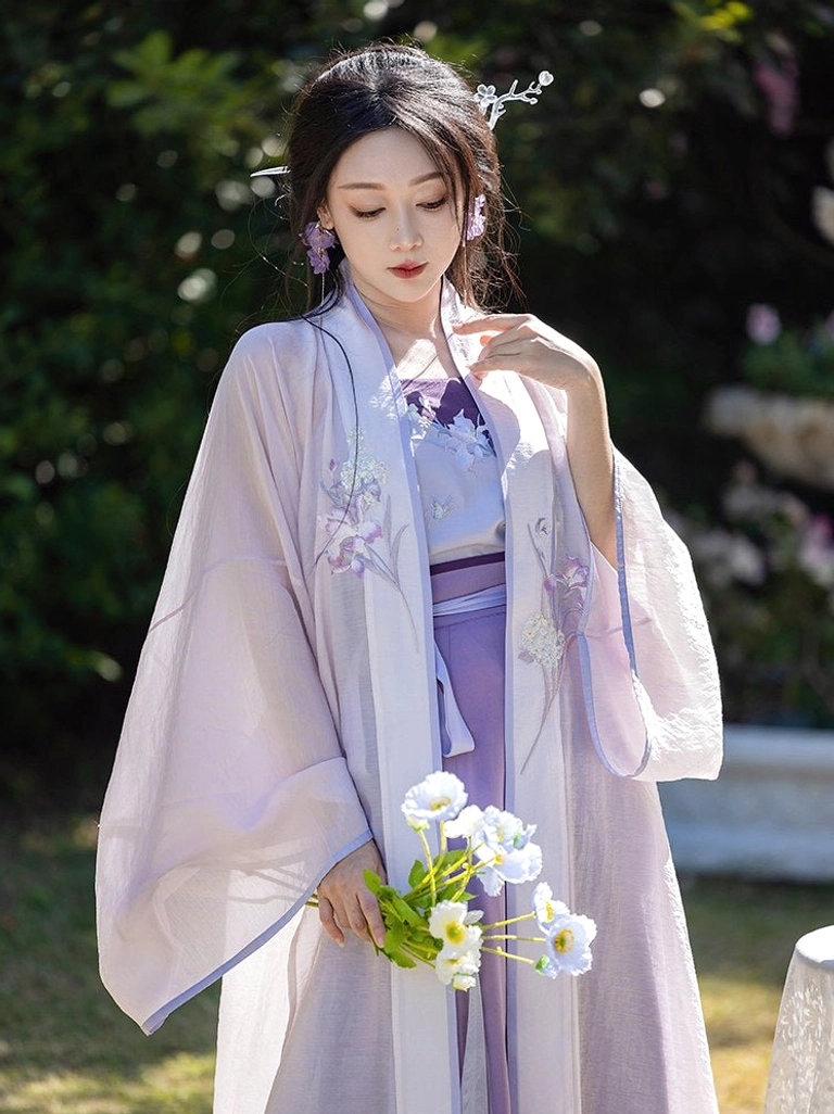 Close view of iris embroidered lavender Song Dynasty Hanfu cardigan layered over a purple camisole with traditional hair ornaments