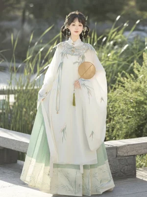 Ivory and light green Ming Dynasty bamboo Hanfu outfit with embroidered robe and mamian skirt, styled with a traditional round silk fan
