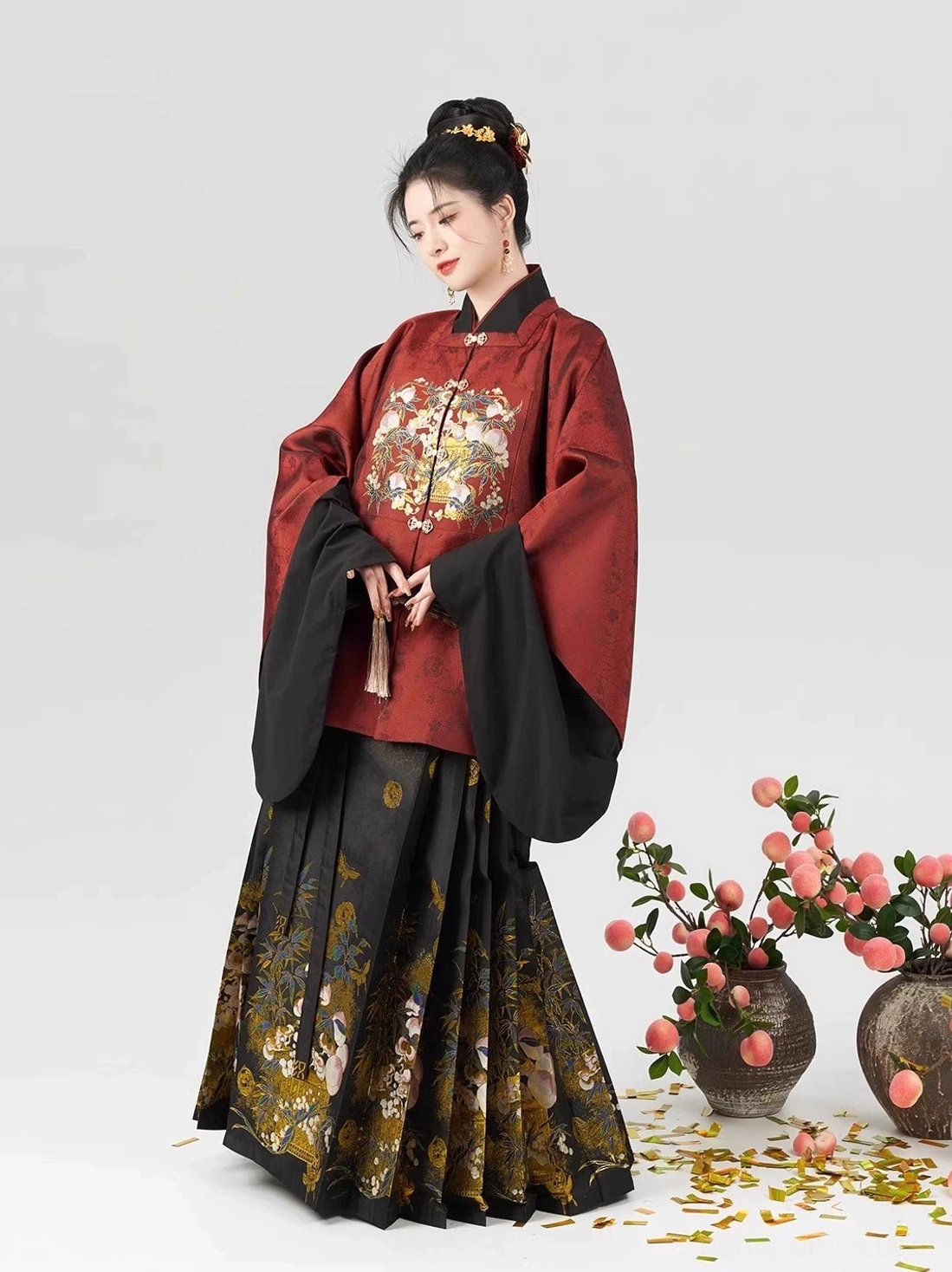 Ming style Chinese New Year dress Hanfu with black mamian skirt gold peach floral print and layered wine red top side front view