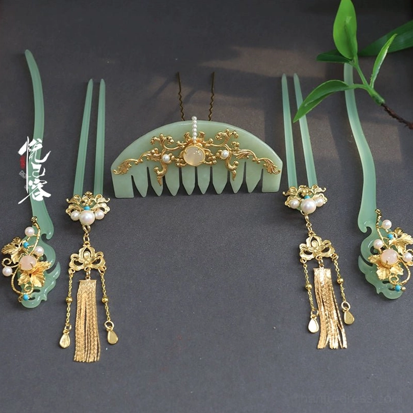 Jade green Hanfu hair accessory collection with decorative hair comb hairpins gold filigree pearl accents and tassel pendants flat lay