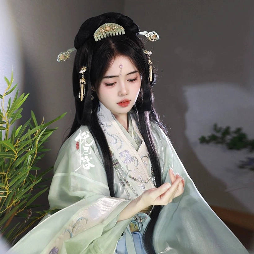 Model wearing jade green Hanfu hair accessories with gold floral ornaments pearl accents and tassel hairpins in a traditional Chinese hairstyle